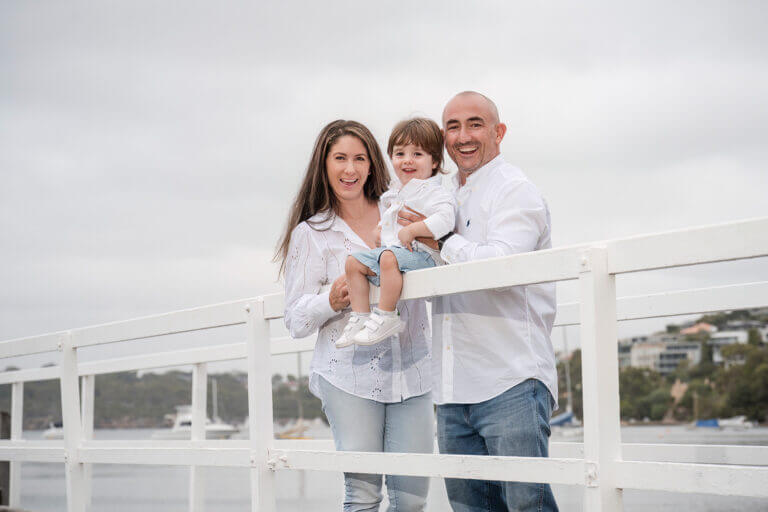 Parents with little boy on jetty at Mosman Bay 768x512