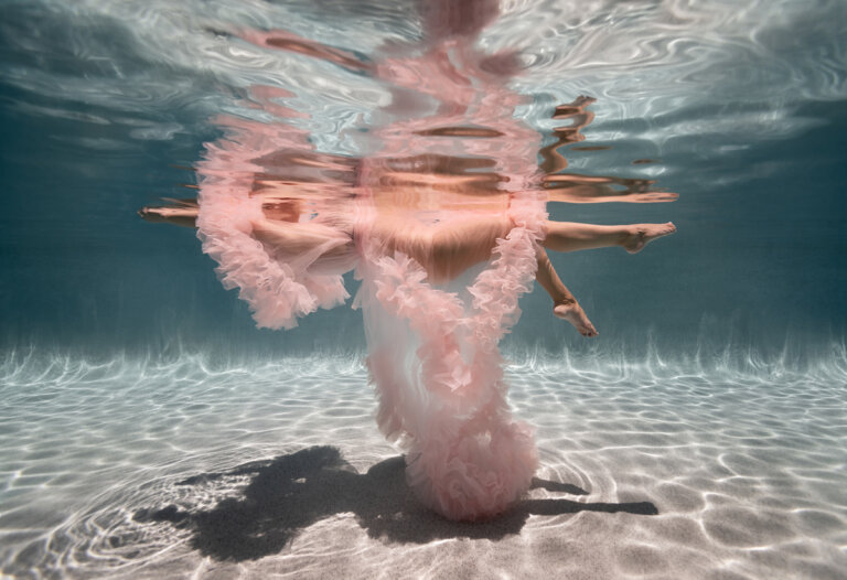 artistic underwater photo of woman in puffy pink dress 768x526